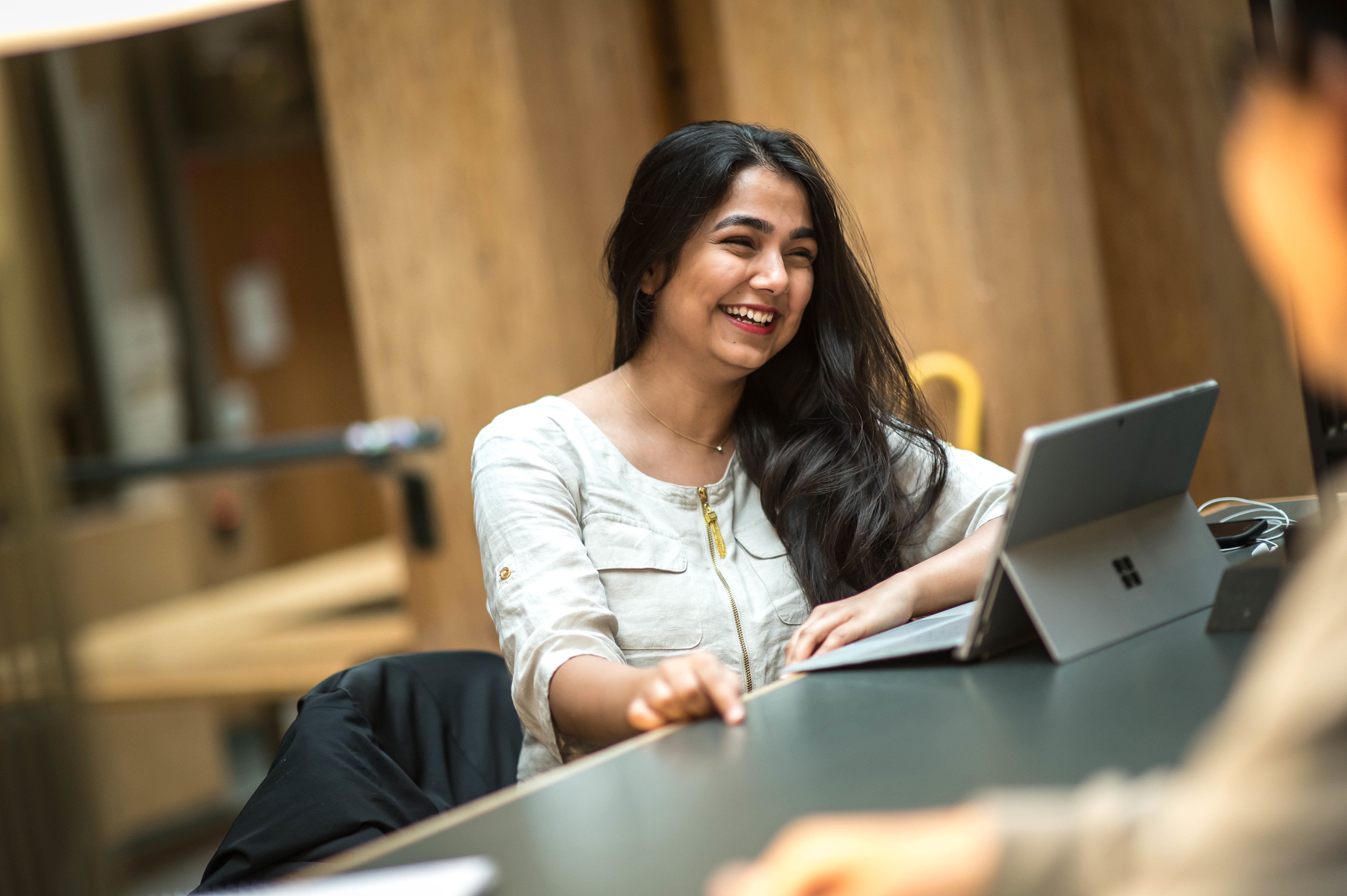 Woman smiling and looking at her laptop