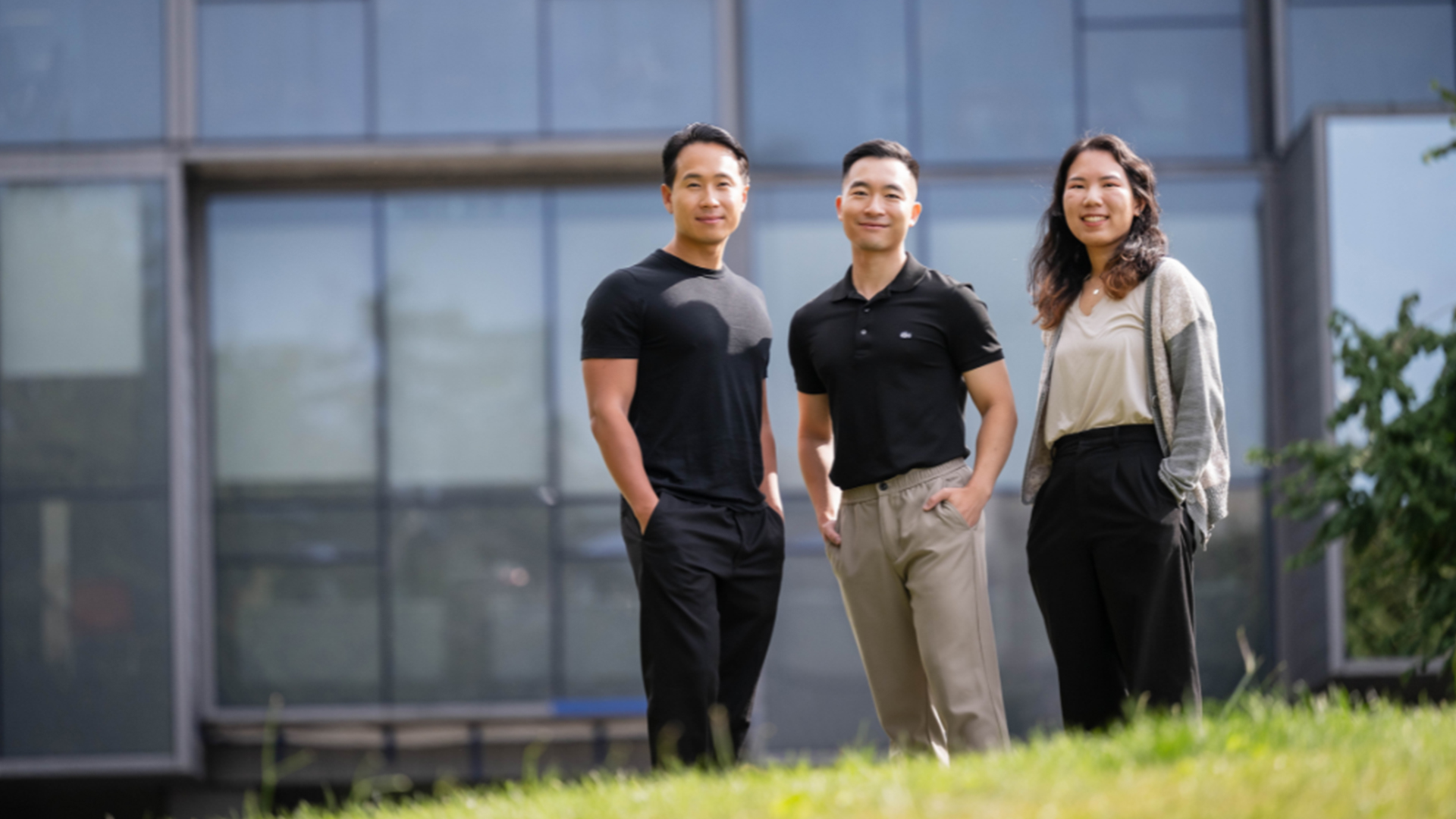 Alex Tang, Tristan Lai, and Lillian Chen stand outside the UBC Pharmaceutical Sciences Building