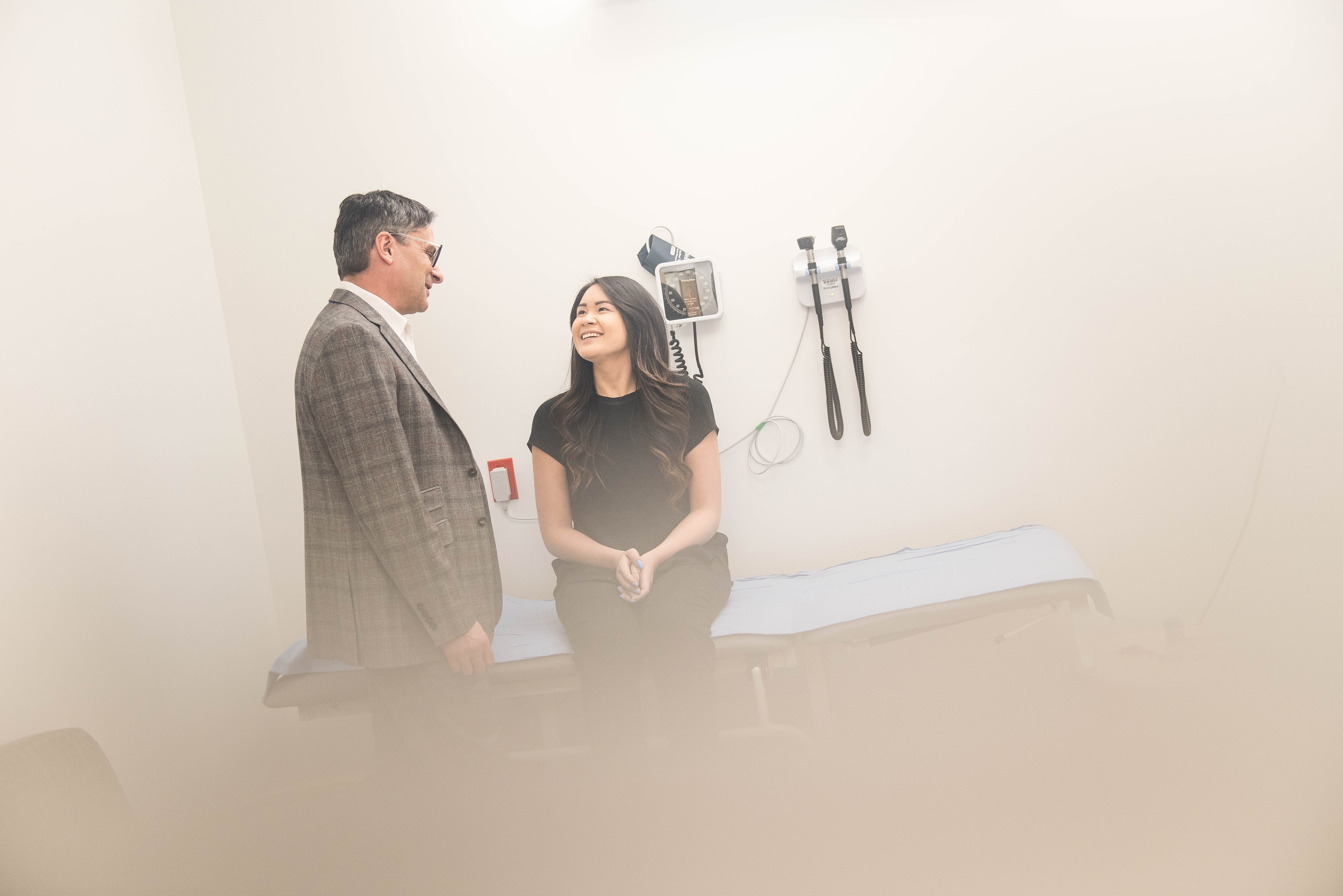 Dr. Anthony Traboulsee (left) consults with a patient at the VCH MS Clinic at UBC Hospital.