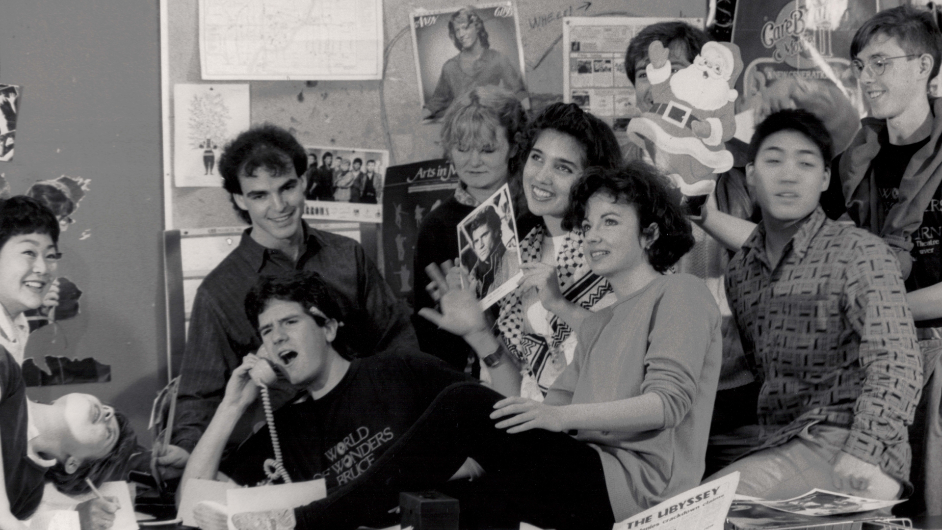 The Ubyssey editorial team pose dramatically around a desk