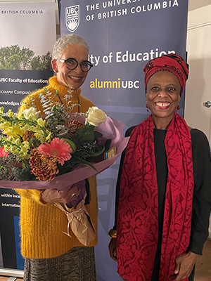 Valerie Jerome holding flowers and Dr. Annette Henry standing next to her