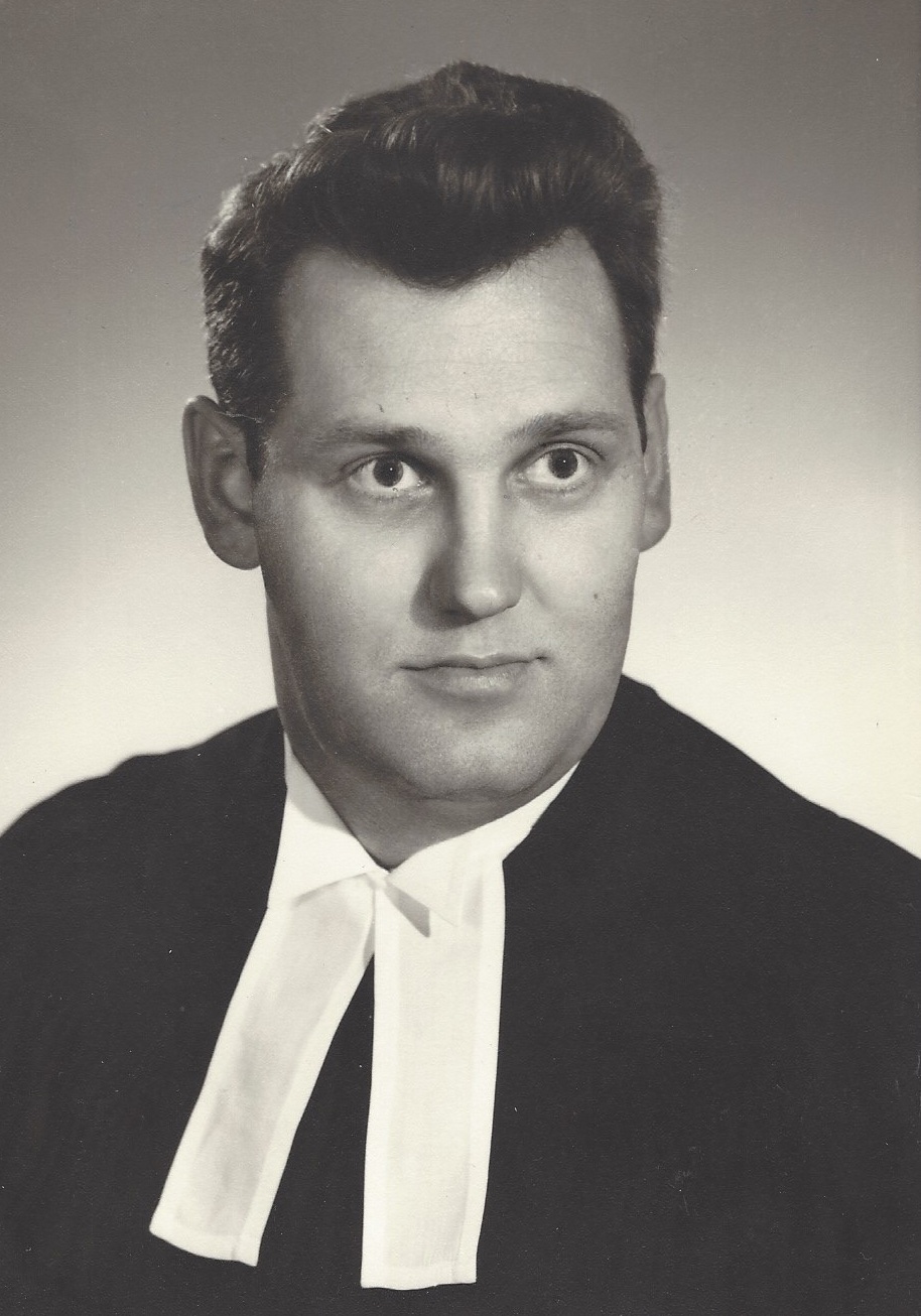 A black and white portrait photo of Allan John Achtem with black hair in formal dress.