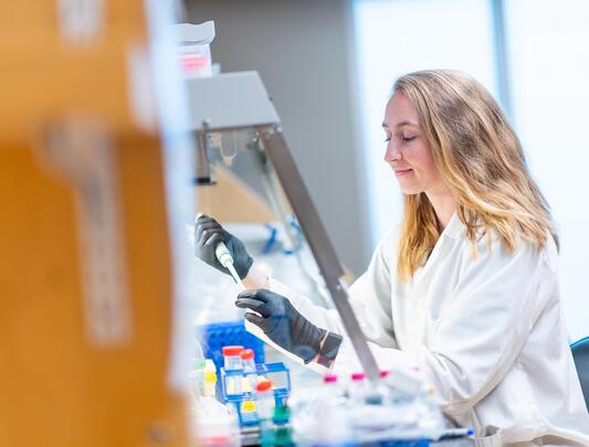 A female scientist works in a lab at UBC.
