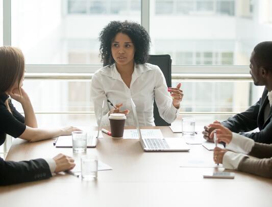 Black woman leading business meeting