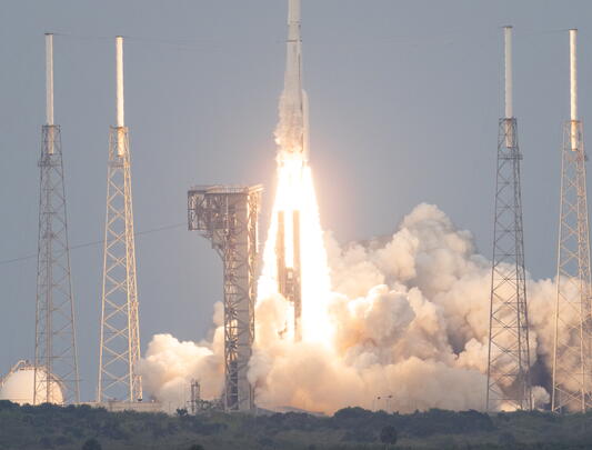 Rocket taking off with cloud of exhaust