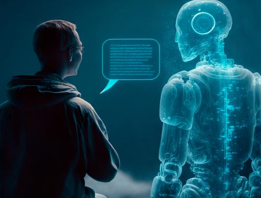 The back of a human and a hologram of a robot, with both staring at a screen with projected text