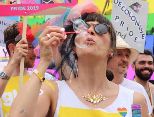 Hana blowing bubbles during a Pride parade in London