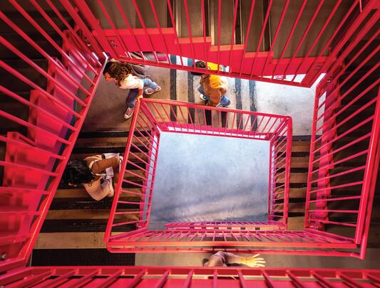 Bird's eye view of people walking up stairwell