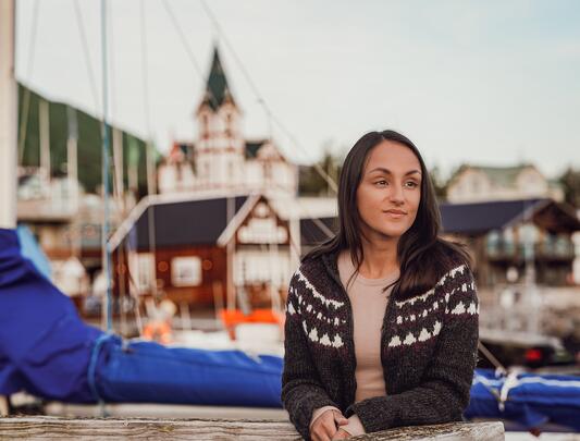 Charla Basran at Húsavík Harbor with a church in the background