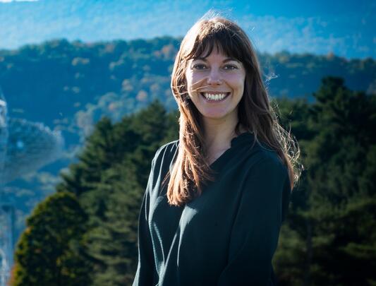 Smiling woman in front of outdoor radio telescope