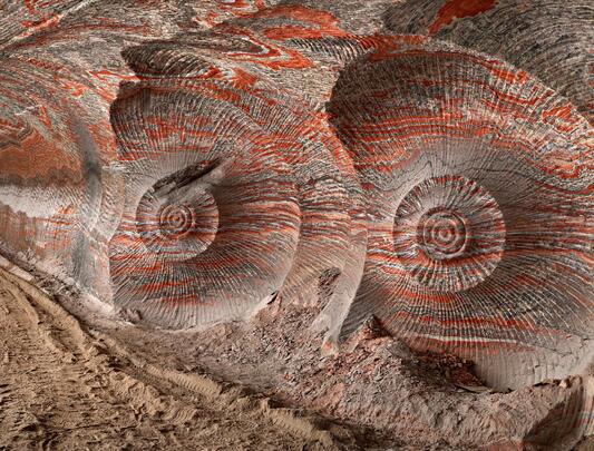 The Uralkali Potash Mine: spiralling swirls of earth like nautilus shells, shot through with streaks of red.