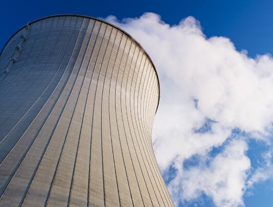 A nuclear reactor tower against the blue sky.