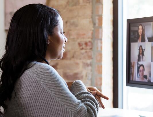 A woman at her desk on a Zoom call