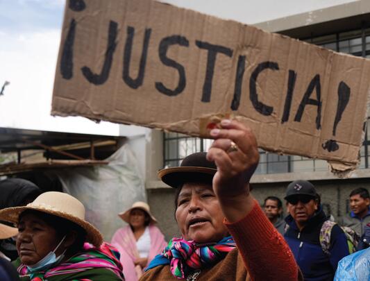 At demonstration, protestor holds sign in Spanish that says "­¡Justicia!" 