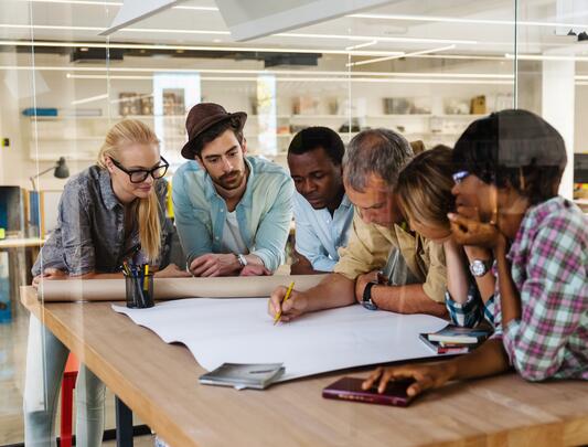 Group of people in an office having a meeting at a table