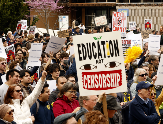Marching protesters holding signs 