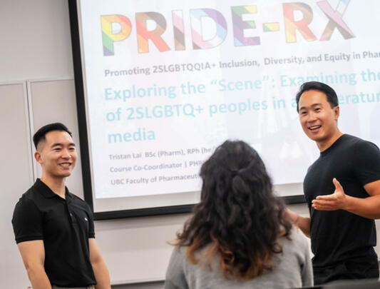 Tristan Lai, Alex Tang, and Lillian Chen chat in front of a slideshow at a PRIDE-RX presentation