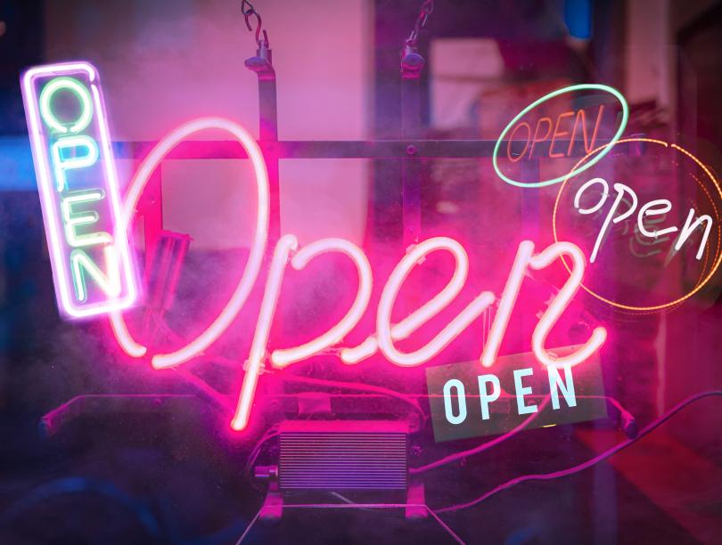 Neon light sign with the words "open".
