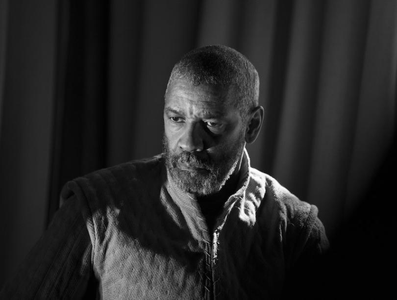 A black and white headshot of Denzel Washington from the film "The Tragedy of MacBeth"