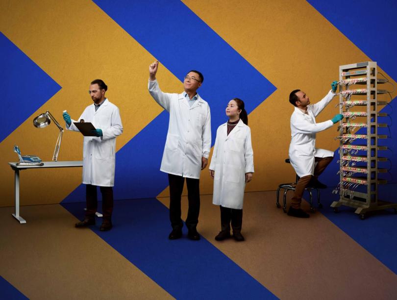 Dr. Jian Liu and his research team, against a blue backdrop with yellow chevrons pointing right