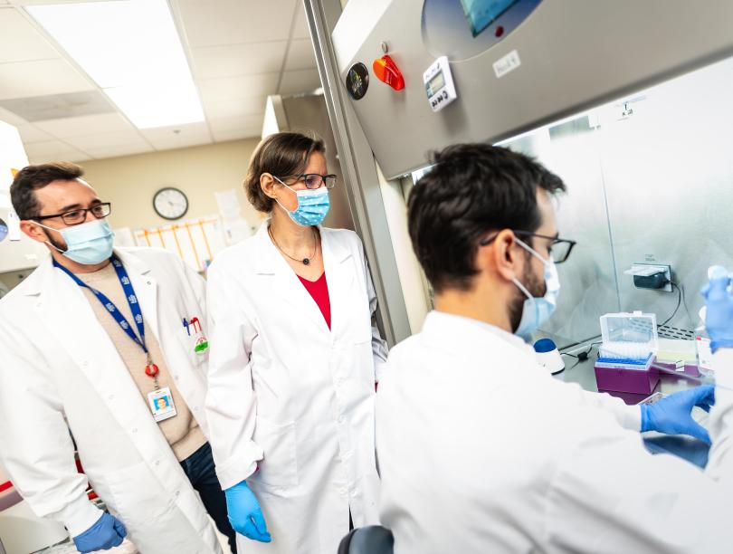 Three UBC researchers in a lab
