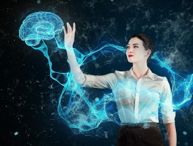 Woman holding her hand up to a holographic brain