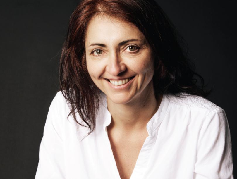 Headshot of Dr. Kalina Christoff smiling against a dark background