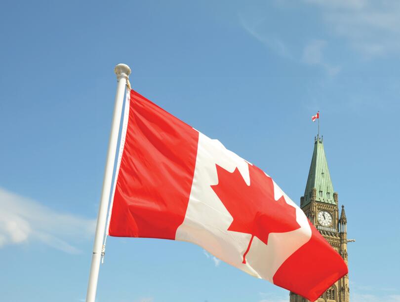 Canadian flag flies before Parliament building