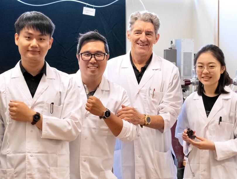 Four researchers, with three displaying watches on their wrists