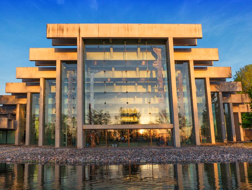 The Museum of Anthropology's concrete and glass facade looking glorious in the golden hour and reflecting in the reflecting pond 