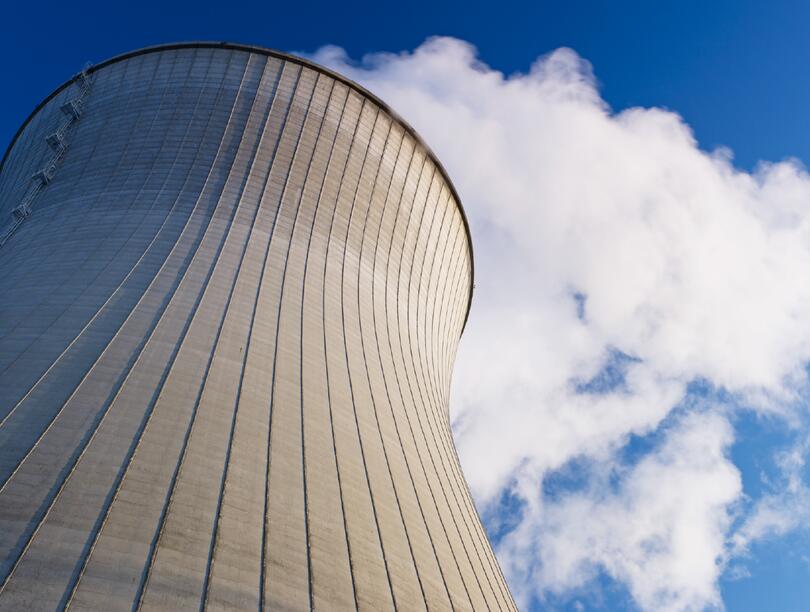 A nuclear reactor tower against the blue sky.