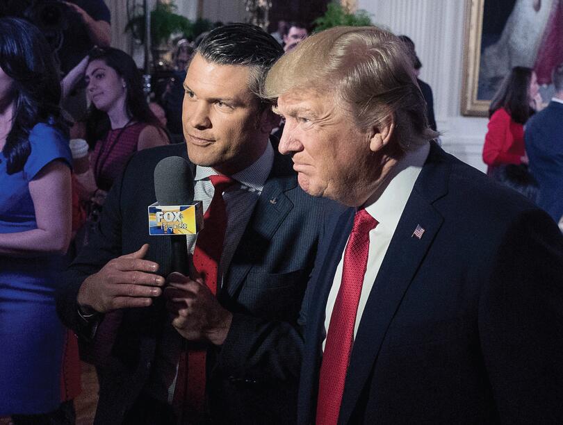 President Donald Trump with Pete Hegseth speak into microphone
