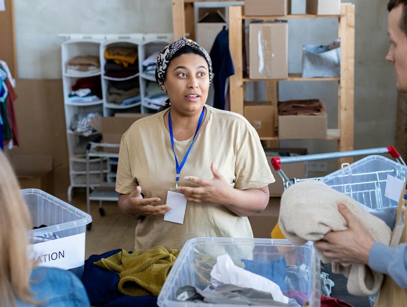 Woman talks to two other people in a storage room