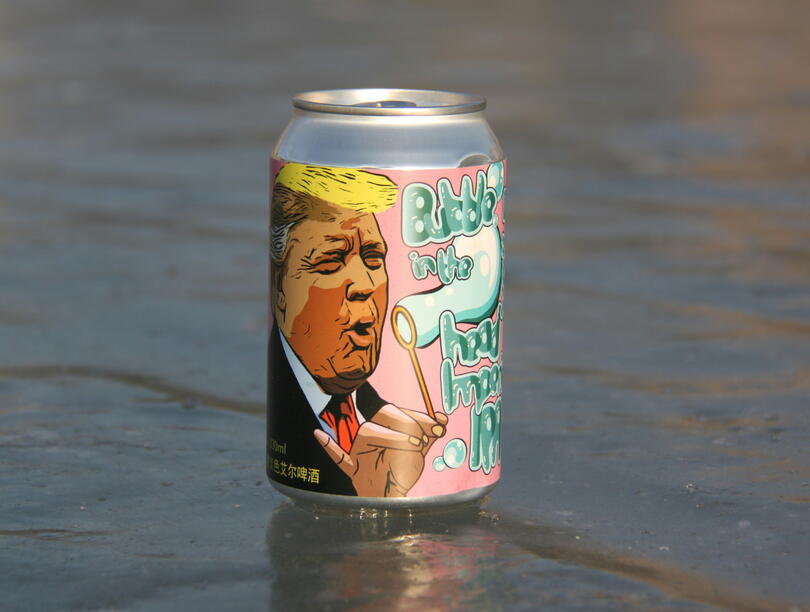 Beer can (with illustration of Trump) sitting on water