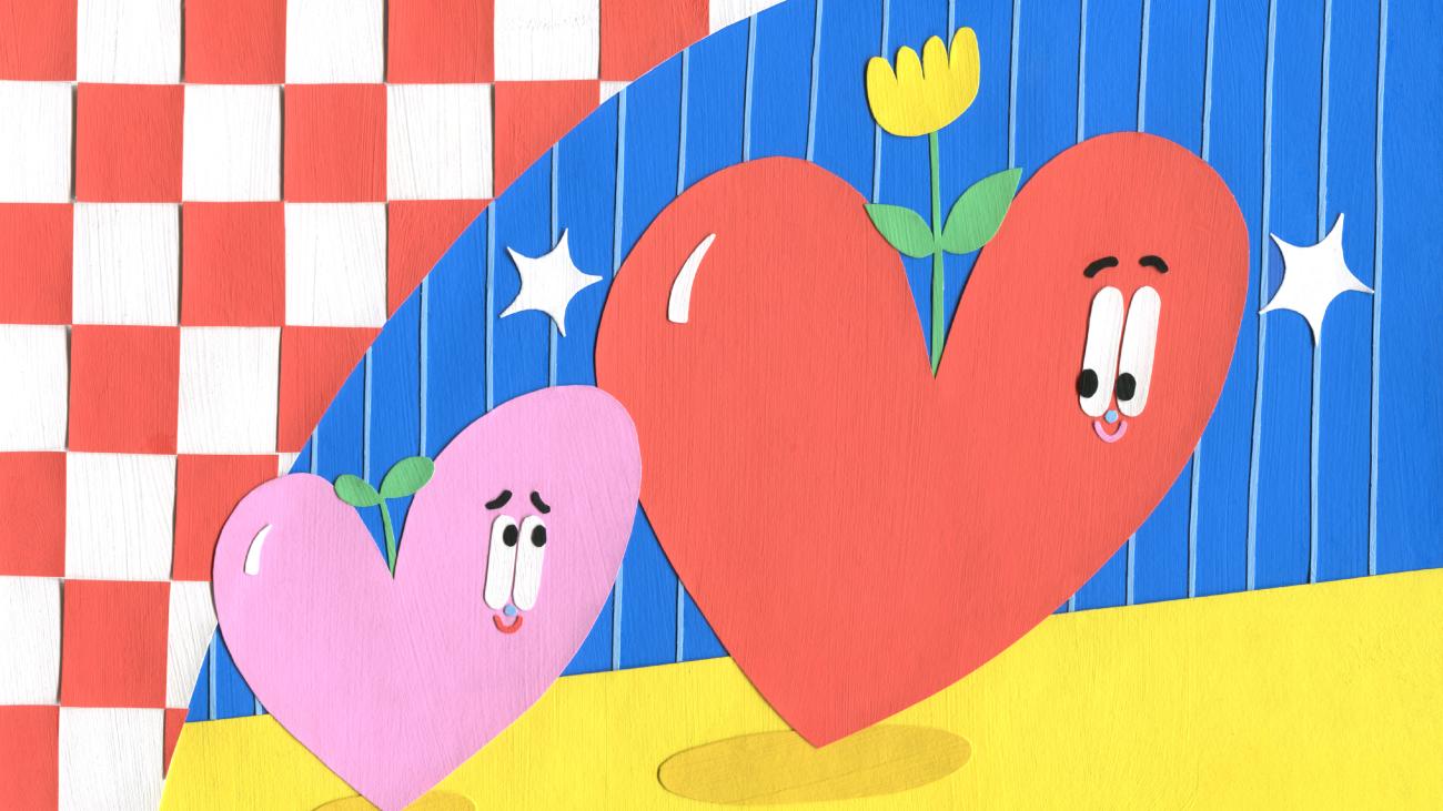 A colourful drawing of two hearts, looking at each other and sprouting flowers.