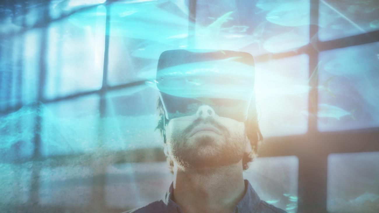 Photo of a man looking up with a VR headset on.