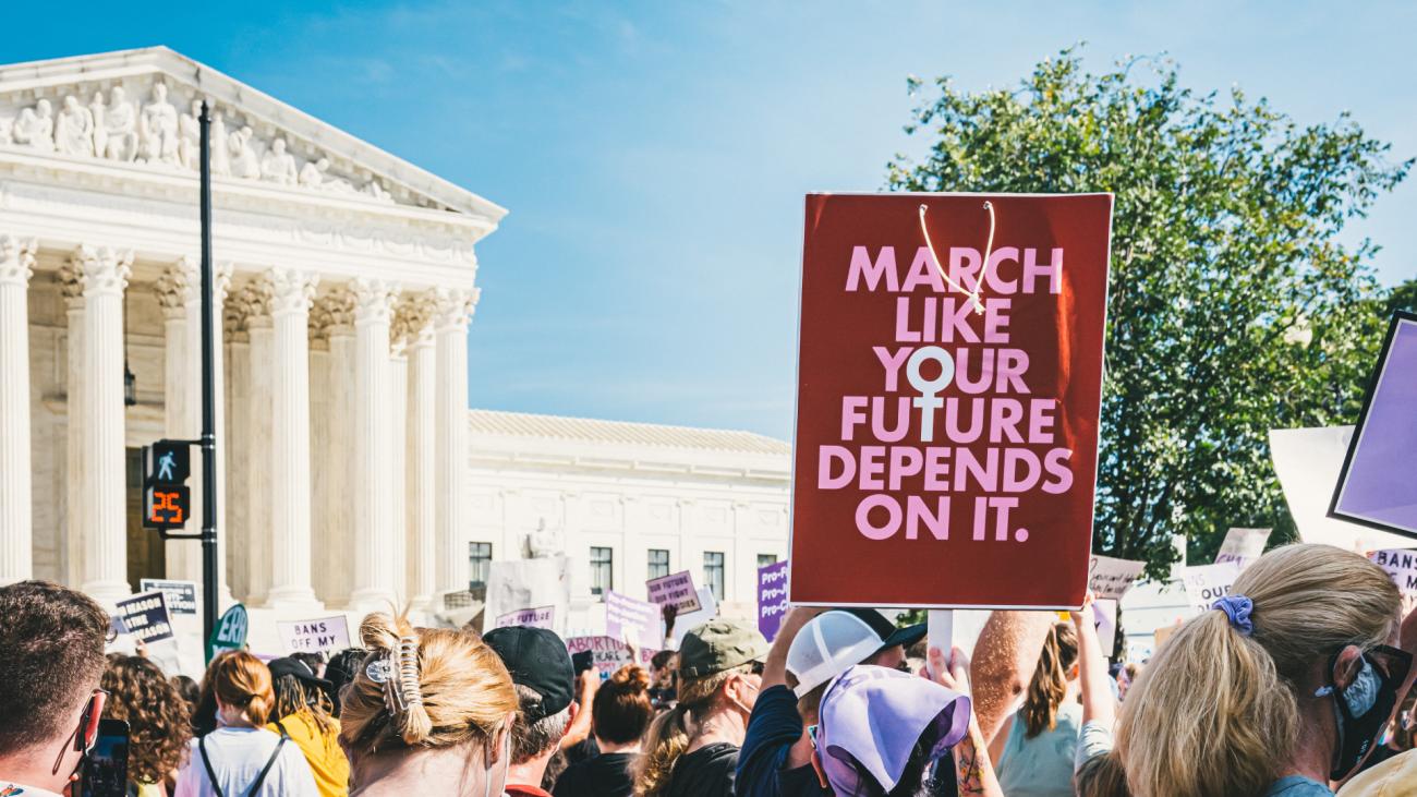 Crowd outside the U.S. Supreme Court, protesting the possible overturning of Roe v. Wade. One prominent sign reads: "March like your future depends on it."