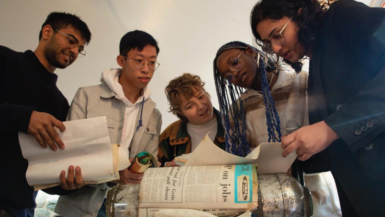 Students look at contents of UBC Great Trek time capsule