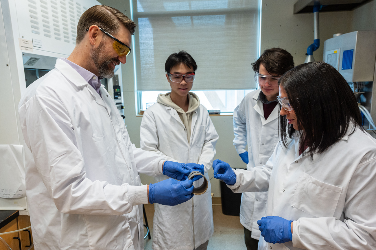 Dr. Yasmine Abdin (right) and her collaborators in lab wear at UBC.