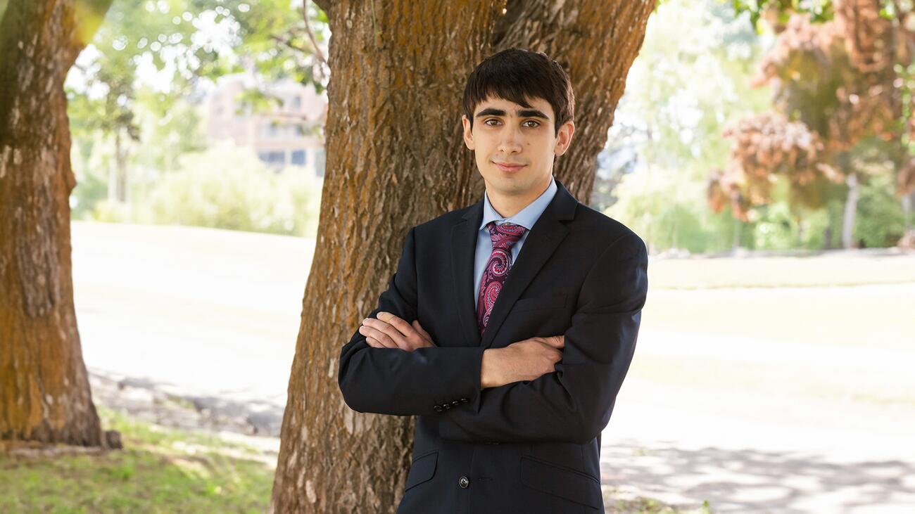 Headshot of Isaac Richman standing next to a tree