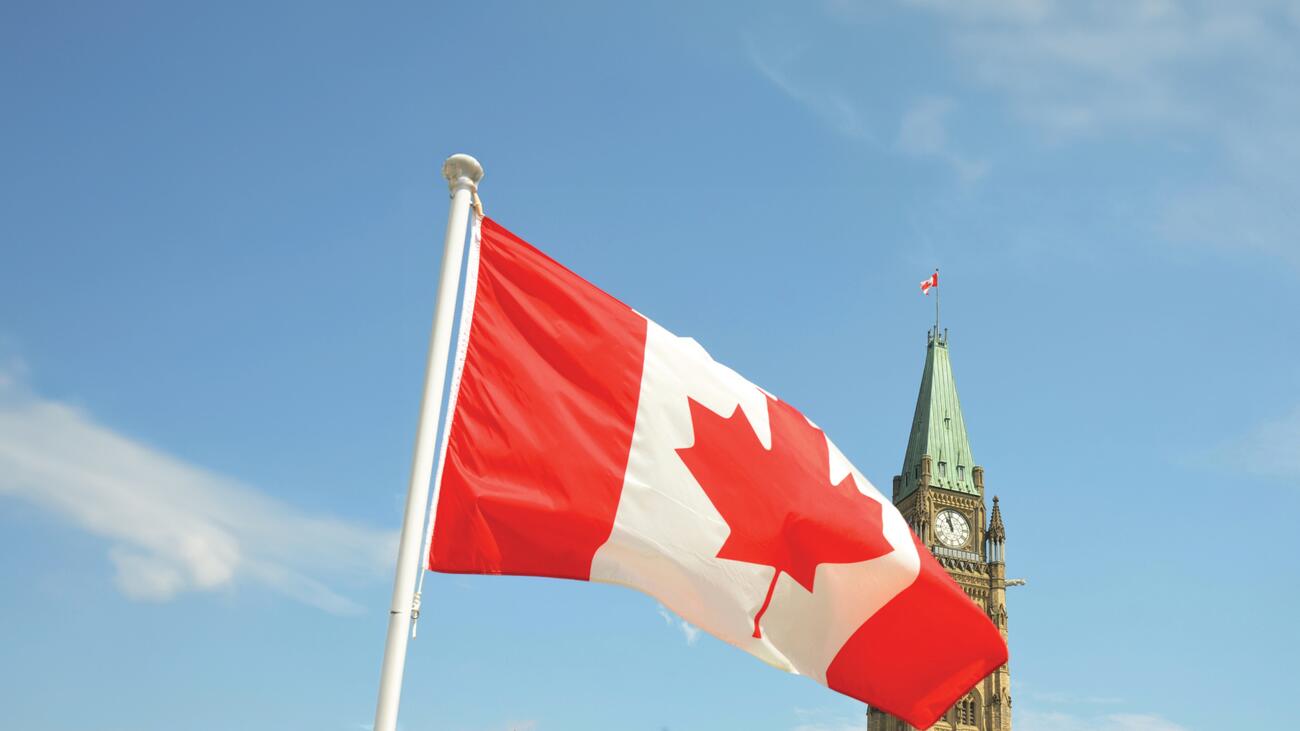 Canadian flag flies before Parliament building