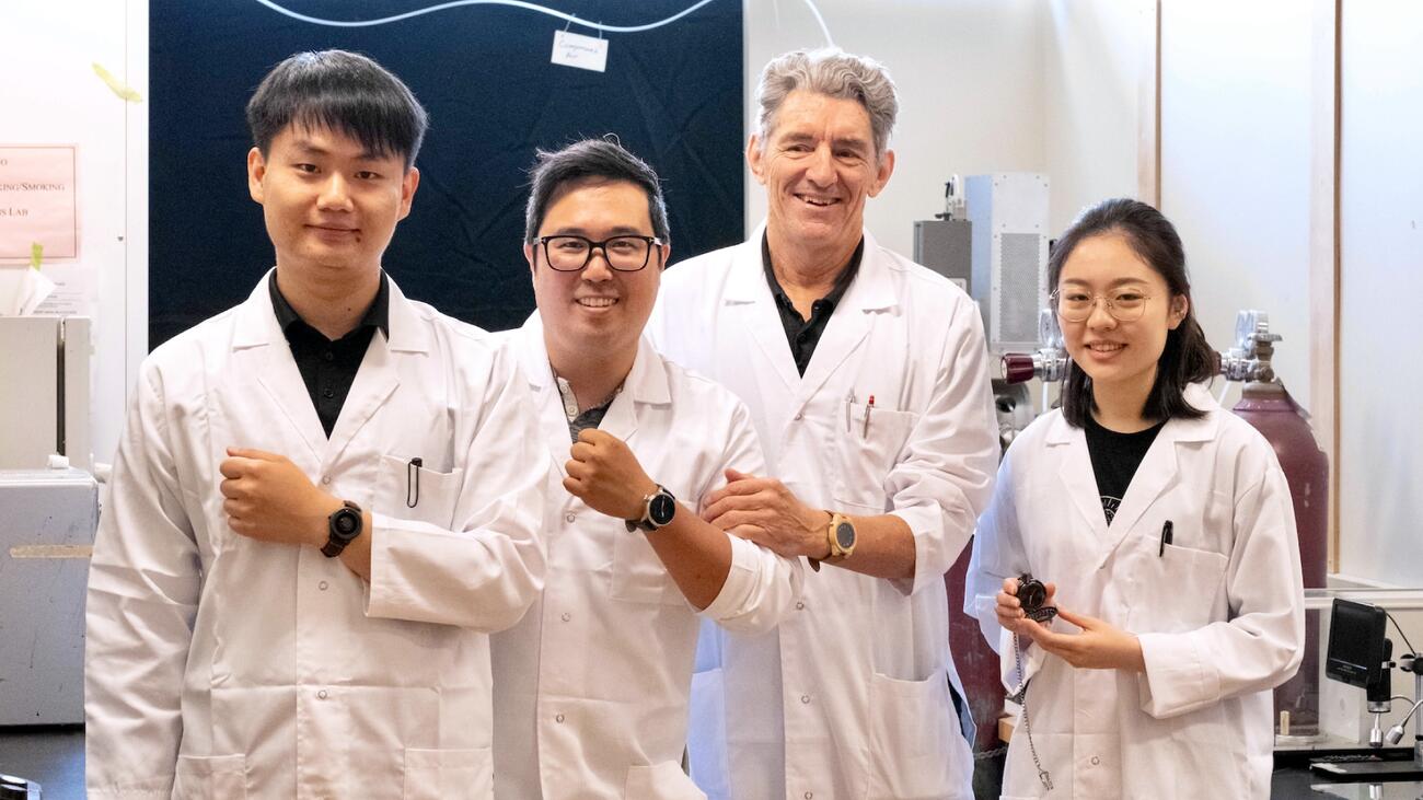 Four researchers, with three displaying watches on their wrists