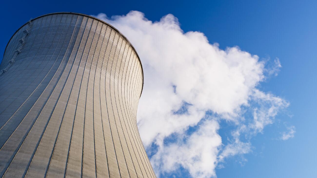 A nuclear reactor tower against the blue sky.