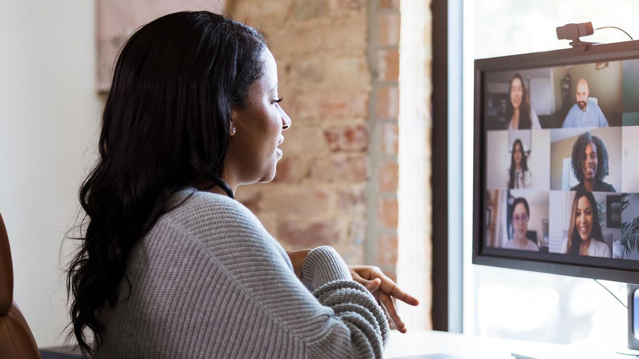 A woman at her desk on a Zoom call