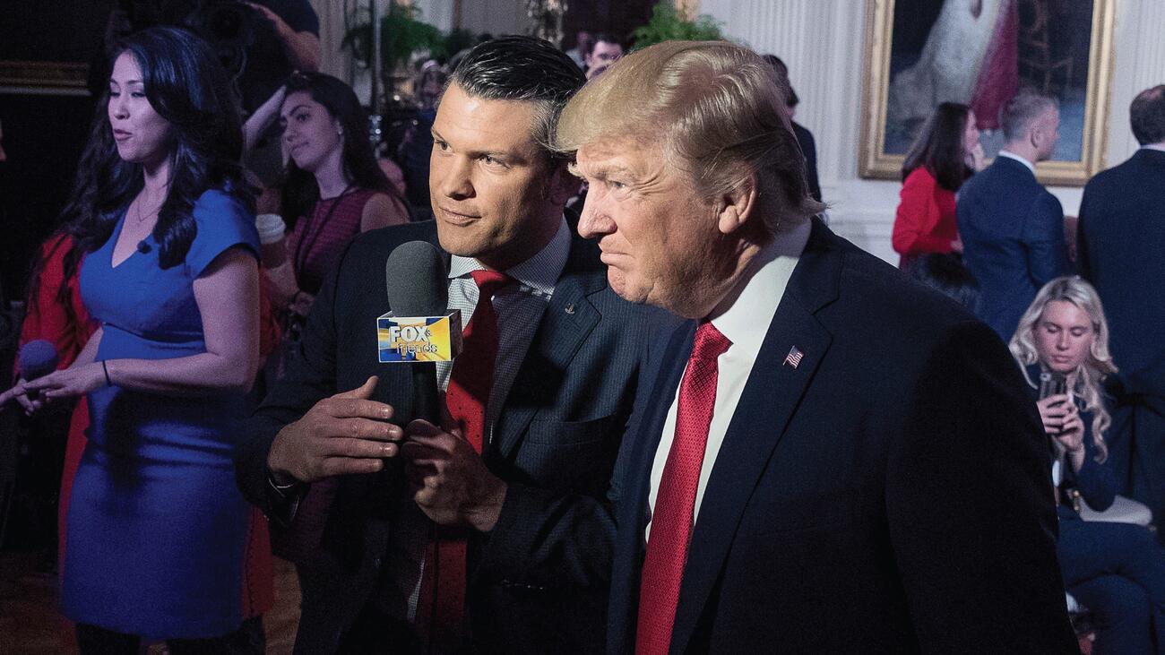 President Donald Trump with Pete Hegseth speak into microphone