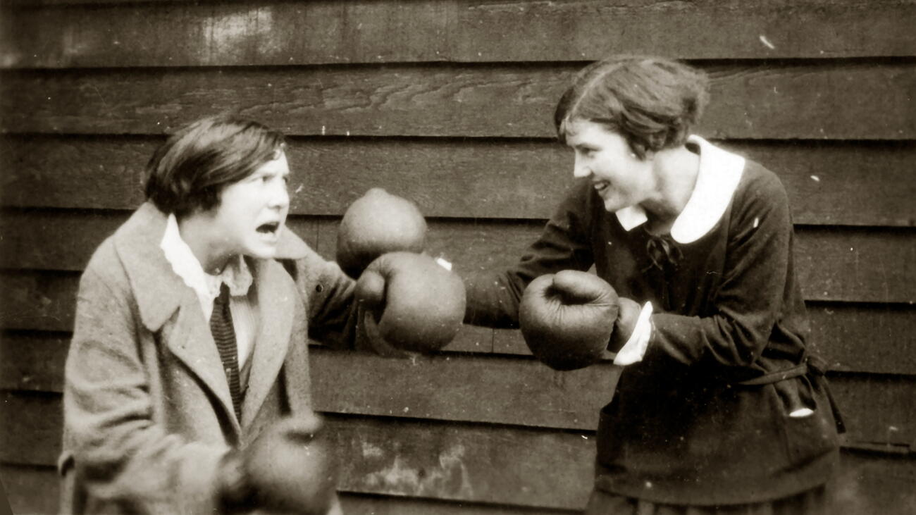 Two students pretend to box with boxing gloves