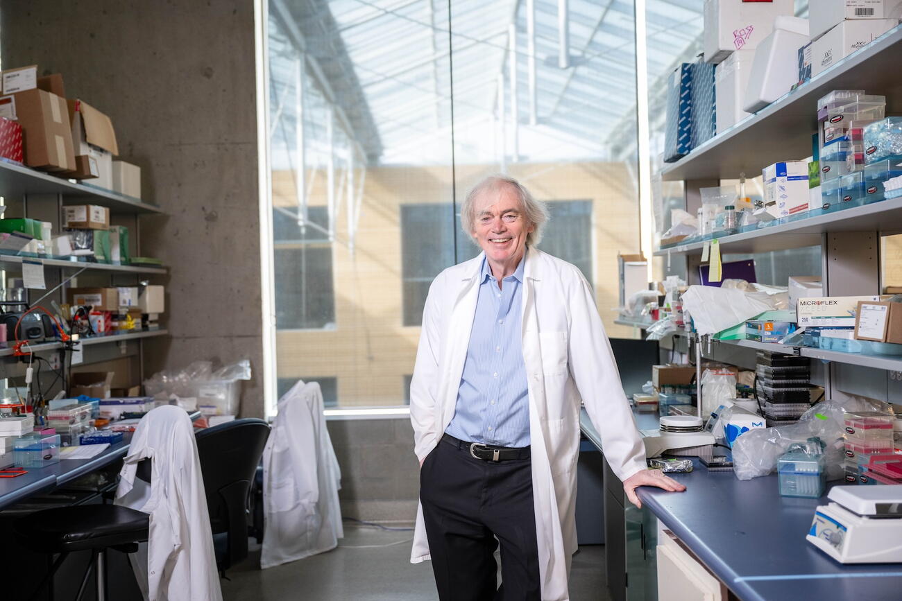 Man in lab coat stands in lab