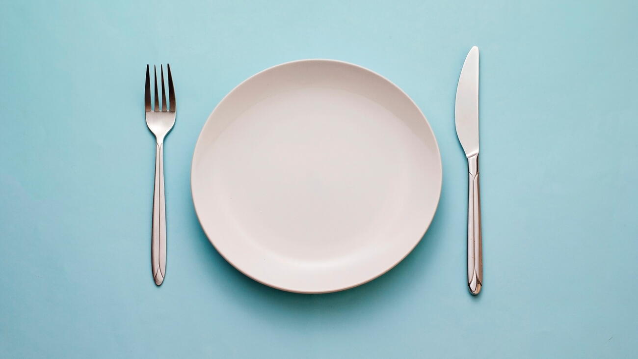 Empty plate with fork and knife