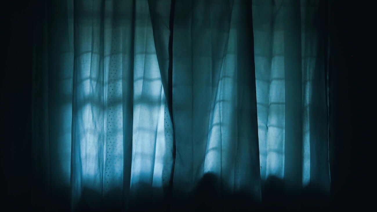 Curtains illuminated by glow through a window