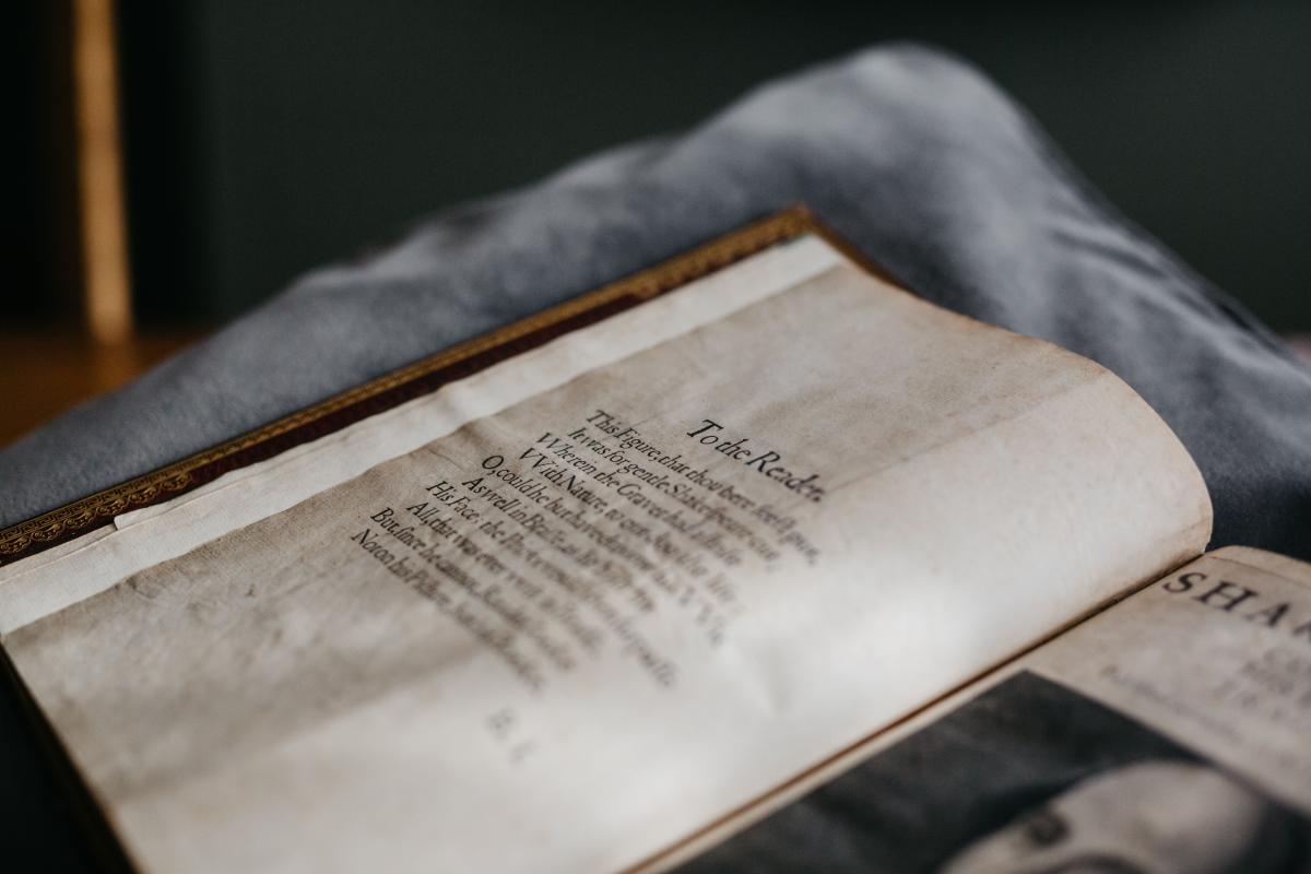 William Shakespeare's First Folio, opened to a page with the heading text "To the reader"